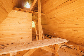 Construction or repair of a wooden house made of planks. Prices for building materials and attic concept