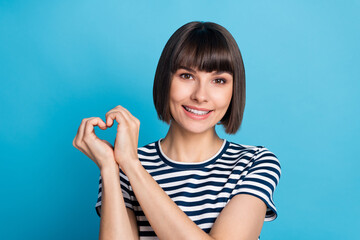 Photo of charming happy affectionate woman hold fingers heart shape isolated on pastel blue color background