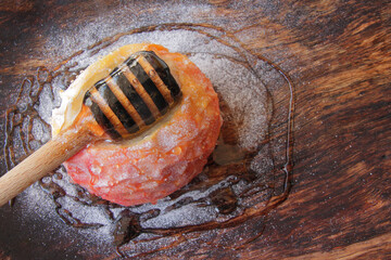 New Year's dessert from apple with honey, on a wooden plate