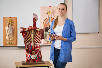 Anatomy teacher and her students during a lesson