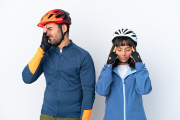 Young cyclist couple isolated on white background unhappy and frustrated with something
