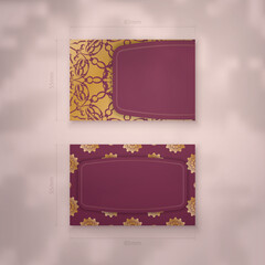 A presentable burgundy business card with a luxurious gold pattern for your contacts.