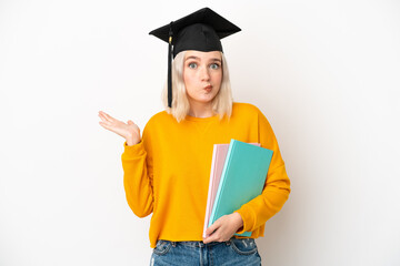Young university caucasian woman graduate isolated on white background having doubts while raising...