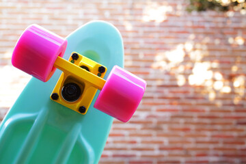 Penny board skateboard with space for text at bricks wall 