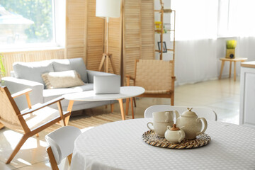 Tea set on dining table in studio apartment