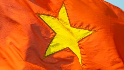 Close up of the red Vietnam National Flag with a gold star in the middle
