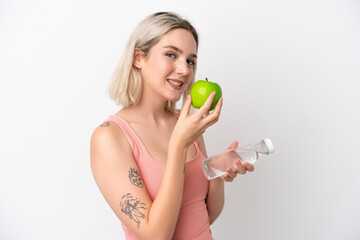 Young caucasian woman isolated on white background with an apple and with a bottle of water