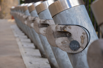 Close up of a row of numerous empty bike share stations