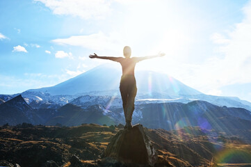 Hiker Young Woman Rises To The Mountain Top Against Backdrop Of Sunshine