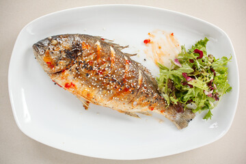 fried fish with fresh herbs and lemon