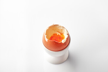 Healthy breakfast - soft boiled egg over white background.