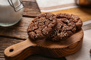 Board with tasty chocolate homemade cookies on wooden background