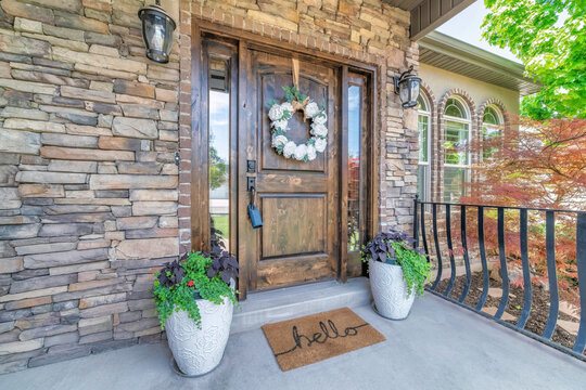 Wooden front door of a house with lockbox and curb appeal
