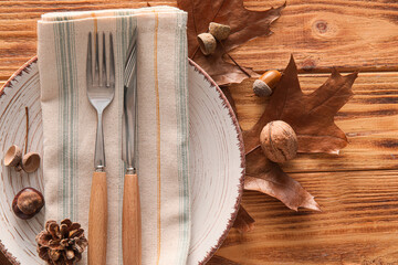 Composition with table setting and autumn decor on wooden background