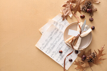 Composition with table setting, music notes, autumn decor and blank tag on beige background