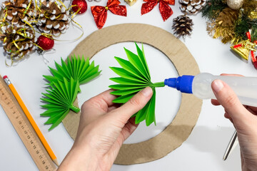 Christmas wreath made of colored paper. DIY concept. Handmade at home. Step-by-step instruction....