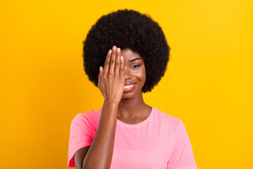 Fototapeta na wymiar Photo of young cheerful black girl happy positive smile close face hand look vision oculist isolated over yellow color background