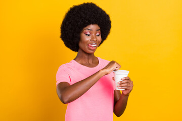Photo of young afro girl happy positive smile hungry lick tongue lips food eat open jar isolated...