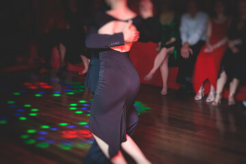 Couples dancing traditional latin argentinian dance milonga in the ballroom, tango salsa bachata...