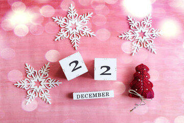 Calendar for December 22: cubes with number 22, name of the month in English, decorative snowflakes...