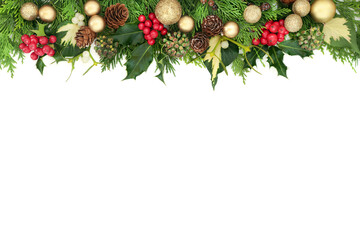 Christmas background border with gold bauble decorations, holly, mistletoe, cedar and ivy on white...