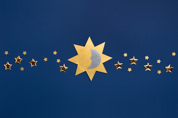 Winter solstice day holiday, December 21. Sun, moon and golden stars symbol on dark blue background.
