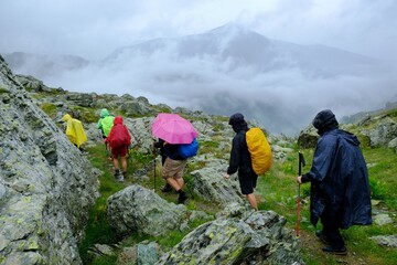 Group of tourists on mountain trail on rainy day. During trekking from Dobërdol in Albania to the...