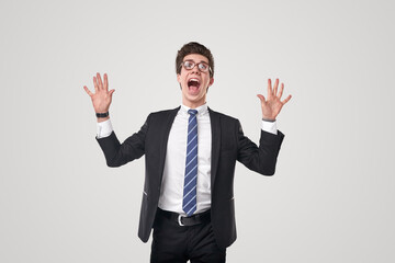 Excited executive worker screaming with raised arms