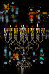 Jewish holiday with burning candles lit for night of hanukkah menorah