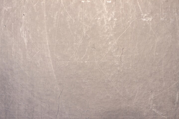 The surface of a scratched sheet of metal, with dots, potholes and scratches. Uneven texture with lines, stripes and pattern.
