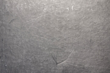 Naklejka premium The surface of a scratched sheet of metal, with dots, potholes and scratches. Uneven texture with lines, stripes and pattern.