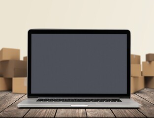 Laptop blank Screen for Infographics Displaying, Standing in Warehouse with boxes.