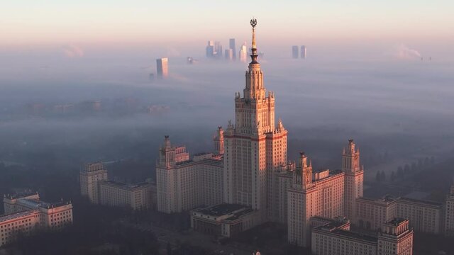 Footage of Moscow State University during sunrise in foggy day