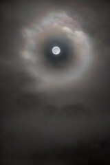 Naklejka na ściany i meble Moon view through a clouds hole