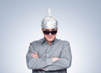 Funny confident smiling man in sunglasses and aluminum foil hat, psychic guru. File contains a path...