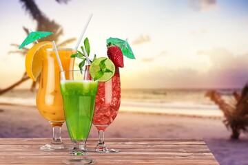 Cocktail drinks with blur tropical beach and sunset in the background