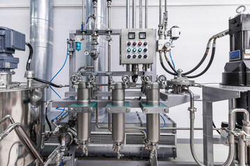 Photo of pipes and tanks. Chemistry and medicine production. Pharmaceutical factory. Interior of...