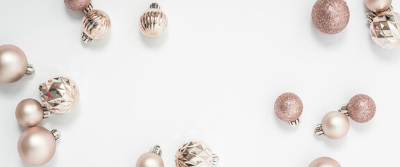 Beautiful golden decorative balls on a white background. Top view, flat lay. Banner.