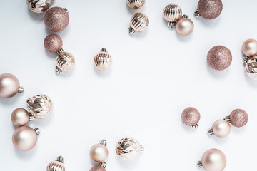 Beautiful golden decorative balls on a white background. Top view, flat lay.