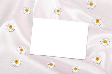 Flatlay of aesthetic styled invitation template. Blank paper sheet card with chamomile flower