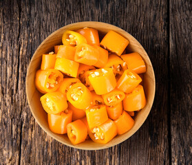 Chili slice in a cup on wood