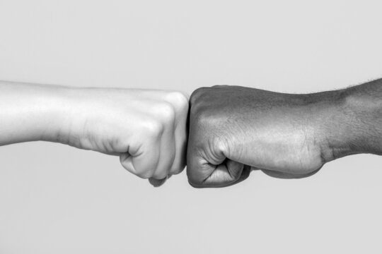 Black African American race male and woman hands giving a fist bump, multiracial diversity, immigration concept. Stop racism campaign. Closeup of multicultural friends giving fist bump to each other
