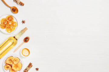 Composition with ingredients hot winter drink mulled wine, white wine, dried oranges and apples, sweets or lollipops