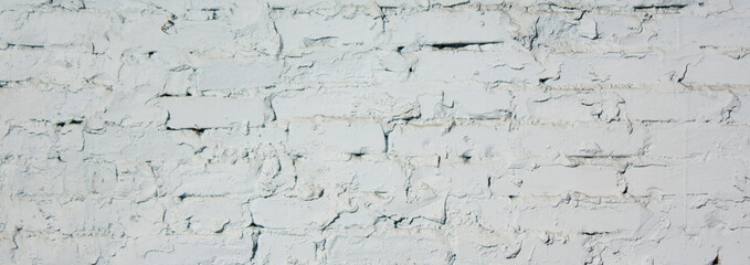 An old brick wall with smeared white brickwork. White, brick texture.