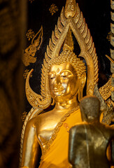 Fototapeta premium Buddha statue at Wat Prasrimahathad Phitsanulok in Thailand. Thai culture, Thai people will go to the temple to pay respect to buddha statue for luck