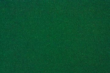Green texture with roughness. Green background. Artificial turf.