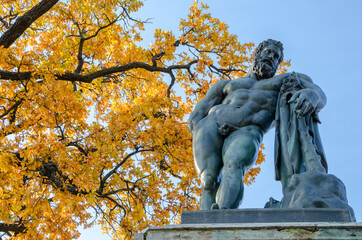 St. Petersburg, Russia - october 2021: Statue of Hercules and autumn foliage (golden autumn) in...