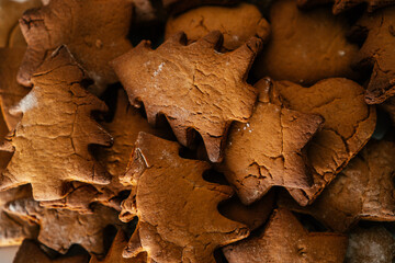 Background image of partially blurred gingerbread cookies in shape of christmas trees, stars and hearts. Copy space