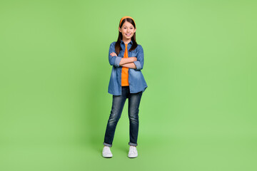 Fototapeta na wymiar Full length photo of nice preteen girl crossed arms wear hoop shirt jeans shoes isolated on green background