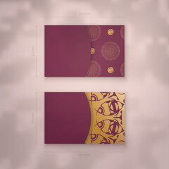 Burgundy business card template with Greek gold ornaments for your business.